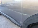 a close up of the side of a car that has been painted black