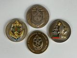 four different coins are shown on a white surface with a white background