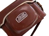 a brown bag that has a brown strap on it