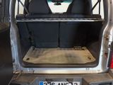 the back of a van with the door open and the back seats down
