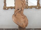 a statue of a woman sitting on top of a marble bust