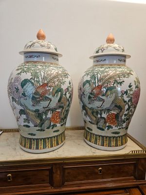 two vases sitting on top of a wooden table