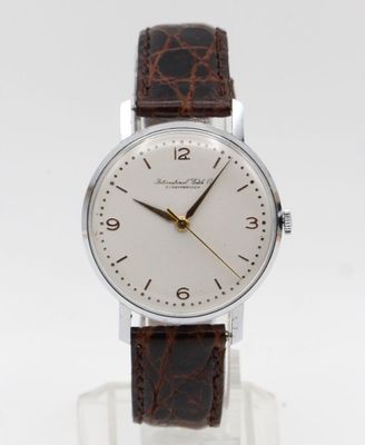a close up of a wrist watch with a brown leather strap