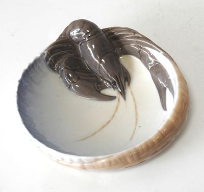 une assiette sur laquelle sont représentés deux oiseaux, posée sur une table