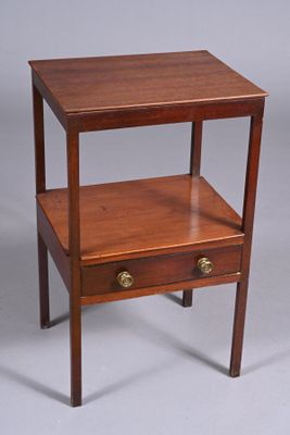 a small wooden table with a drawer on it