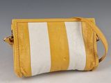 an image of a yellow and white striped purse on a table