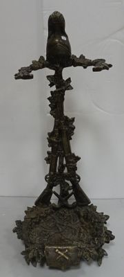 a statue of a bird sitting on a tree branch