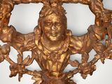 a gold sculpture of a man and a woman in a frame