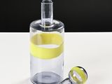 a glass bottle with a yellow tape inside of it