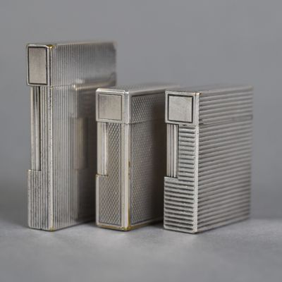 two silver lighters sitting next to each other on a table