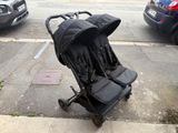 a stroller that is sitting on the side of the street