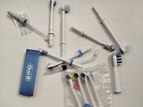 a lot of toothbrushes that are laying on a table