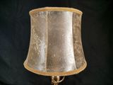 a lamp that is sitting on a table with a black background