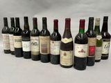 several bottles of wine are lined up in a row on a table