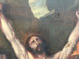 a painting of jesus on the cross in a room