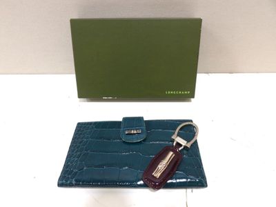 a close up of a wallet and keychain on a table