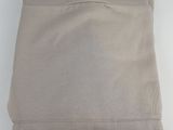 the top of a pair of beige sweaters on a white surface