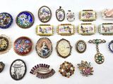 many different pieces of jewelry on a white surface