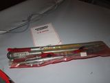 two pens and a pen holder on a table