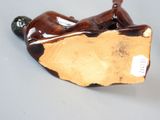 a figurine of a man laying on a wooden block