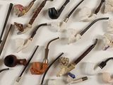 many different types of smoking pipes on the table