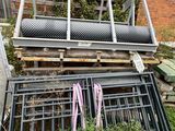 a pile of metal and wood on the side of a building