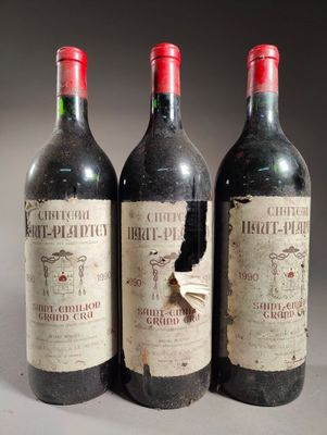 trois bouteilles de vin rouge posées côte à côte sur une table