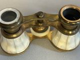 an antique pair of binoculars sitting on top of a table
