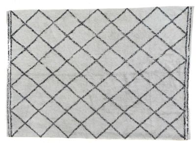 a white rug with a black and white design on it