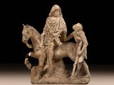 a statue of a man riding a horse with a woman on it