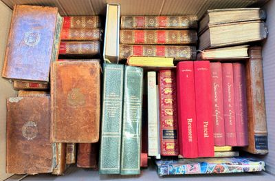 a box full of old books sitting on a table