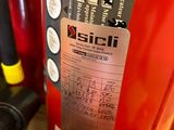 a red fire extinguisor sitting on a table next to other tools