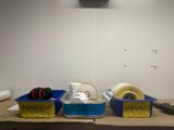 two bins of tape and a pair of scissors on a table