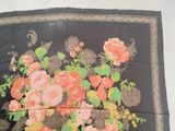 a black scarf with a bunch of flowers on it