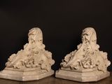 pair of white marble figurines of a woman and a man