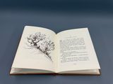an open book with a drawing of a bird on it