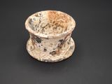 a small bowl sitting on top of a black table