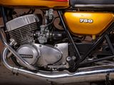 a yellow motorcycle parked in front of a brick wall