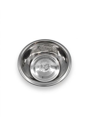 a close up of a metal bowl with a dog ' s head in it
