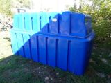 a blue plastic container sitting in the grass