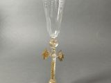 a wine glass with a gold decoration on the stem