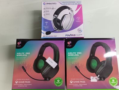 two boxes of gaming headsets sitting on top of a table