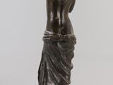 an image of a statue of a woman standing on a pedestal