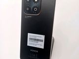 the back of a black phone with a barcode sticker on it