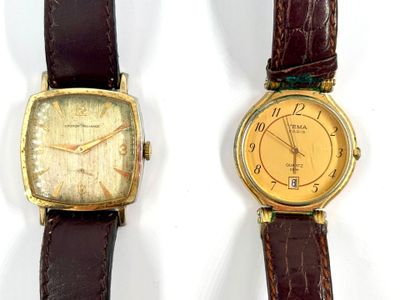 two watches sitting next to each other on a white surface