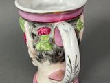 a white cup with a pink handle sitting on a table
