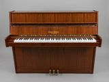a piano with a wooden case sitting on top of it