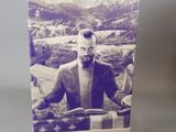 a card with a picture of a man sitting on a motorcycle