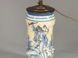 a blue and white vase with a horse and rider on it