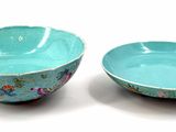 two bowls sitting next to each other on a white surface